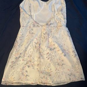 White Revolve short mini dress with flower detailing around the dress